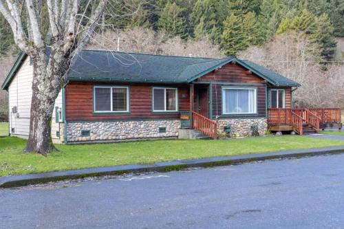 a wooden house with a tree in front of it at Elk Meadow Cabins 19A Johnny Redwood Suite in Orick