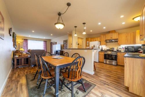 a kitchen and dining room with a table and chairs at Elk Meadow Cabins 19A Johnny Redwood Suite in Orick