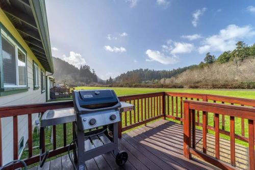 a grill on a deck on a house at Elk Meadow Cabins 19A Johnny Redwood Suite in Orick