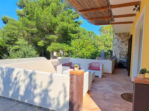 a patio with a white fence and a table and chairs at Domus de mare in Cala Gonone