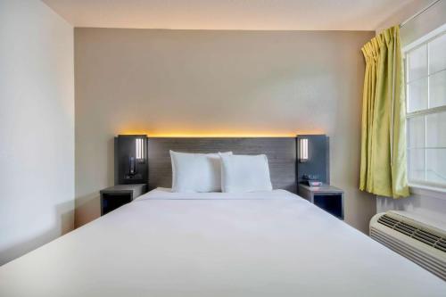 a bedroom with a large white bed and a window at Studio 6-San Antonio, TX - Medical Center in San Antonio