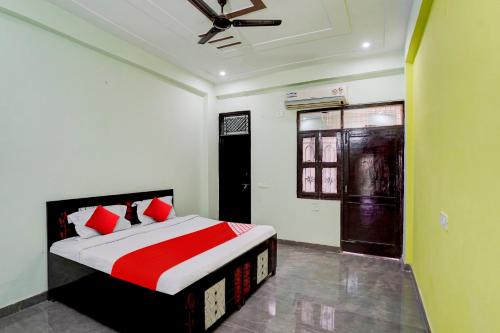 1 dormitorio con 1 cama y ventilador de techo en OYO Flagship J M K Love Residency en Noida