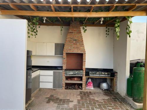 a kitchen with a brick oven in the middle at Casa Finca La 58 Melina Real 