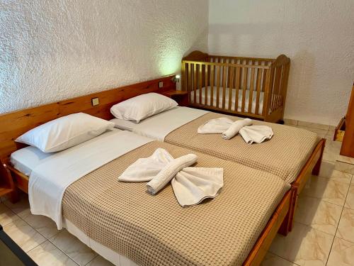 two beds in a room with towels on them at Lefka in Kolymvari
