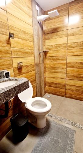 a bathroom with a toilet and a sink at Hotel Platina in Juiz de Fora