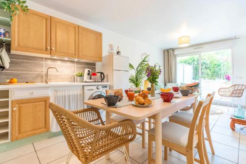 une cuisine avec une table et des chaises dans une cuisine dans l'établissement BAO LOCATION - Ideal Pro & Groupe - Calme - Lumineux - WIFI - Terrasse - Jardin - Plage à 2km - Proche Centre Ville, Gare, Commerces - Parking Privé, à Toulon