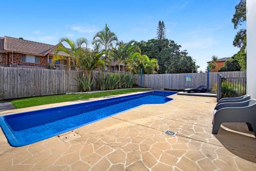 a swimming pool in a yard next to a fence at Ocean Spray 7 in Coffs Harbour