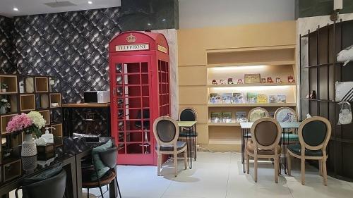 a red phone booth in a room with a table and chairs at Hotel Champs Elysées in Taichung