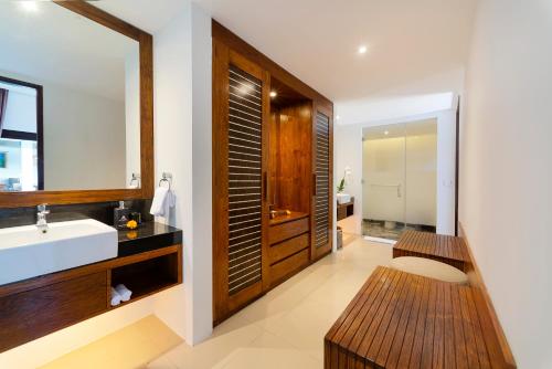 a bathroom with a sink and a mirror at Adepa Resort in Canggu