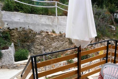 a white umbrella sitting on top of a railing at Apartments by the sea Valun, Cres - 8081 in Valun