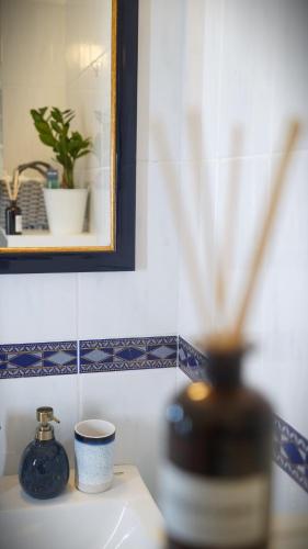 a bathroom with a vase and a cup on a counter at La Casa Nonna in Alsóörs