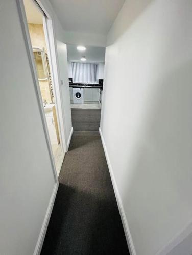 a hallway leading to a room with a kitchen at Cosy Apartment Next To City Centre in Sheffield