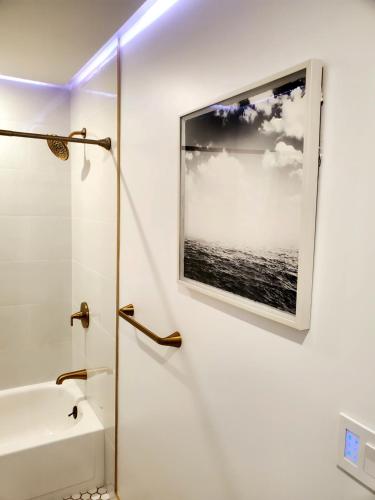 a bathroom with a picture of the ocean on the wall at Cozy 3br/2bath vacation house at Lake Travis in Lago Vista