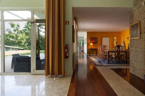 a living room and dining room with sliding glass doors at Quinta das Gerais in Marco de Canavezes