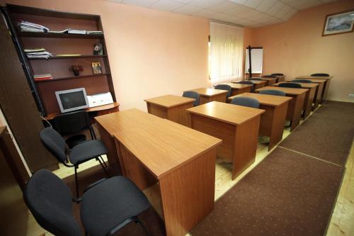 a classroom with rows of desks and chairs at Family Hotel Bansko Sofia in Sofia