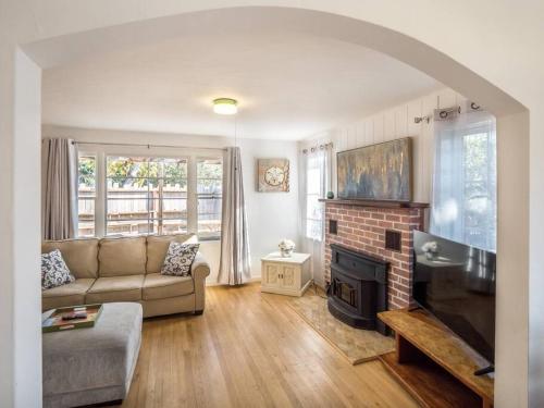 a living room with a couch and a fireplace at Santa Cruz Style Beach retreat, 5min walk to beach in Santa Cruz