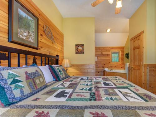 a bedroom with a bed with a quilt on it at Trail’s End, 2 Bedrooms, Hot Tub, Jetted Tub, Gas Fireplace, Sleeps 8 in Gatlinburg