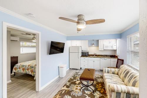 a living room with a couch and a kitchen at Dolphin Court #3 in St. Pete Beach
