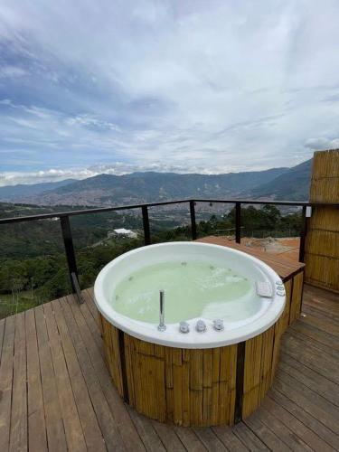 a large wooden tub sitting on a deck at Glamping ecoglam Medellín in Copacabana