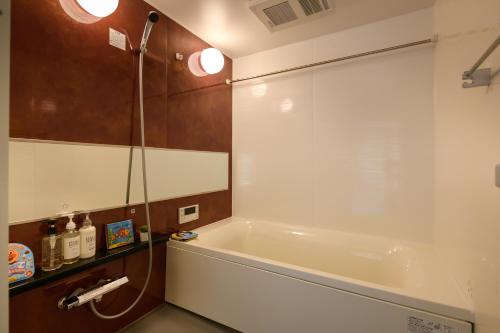 奈良的住宿－Ehon Hotel，设有带浴缸和淋浴的浴室。