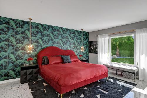 a bedroom with a red bed and a green wall at Casa Lazo in Palm Springs