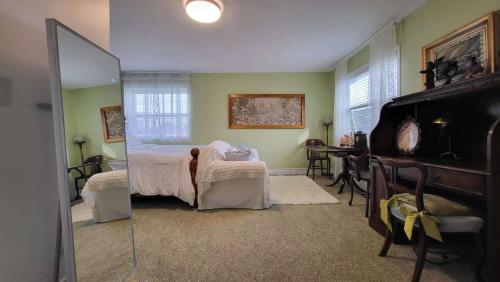a bedroom with a bed and a table and a mirror at sweet home in Richmond