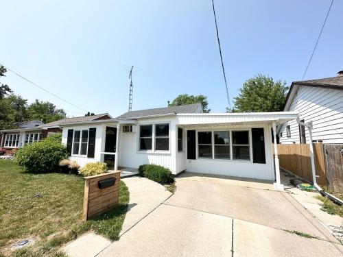 a white house with a driveway in front of it at Park Street Paradise! in Leamington