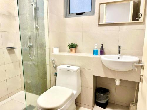 a bathroom with a toilet and a sink and a shower at Deco Home @ Imago The Loft in Kota Kinabalu