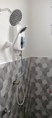 a shower with a blow dryer in a bathroom at D'NAS HOMESTAY - Muslm Only in Sungai Besar