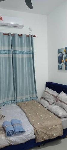 a bed in a room with a curtain at D'NAS HOMESTAY - Muslm Only in Sungai Besar