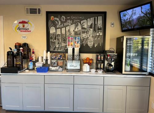 a counter in a coffee shop with many items on it at Super 8 by Wyndham Red Bluff in Red Bluff