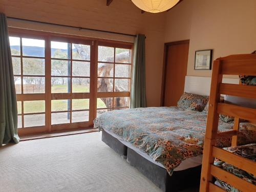 a bedroom with a bed and a large window at Beulah by the Lake in Kalkite