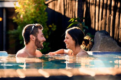 a man and a woman in a swimming pool at Prince's Gate Hotel in Rotorua