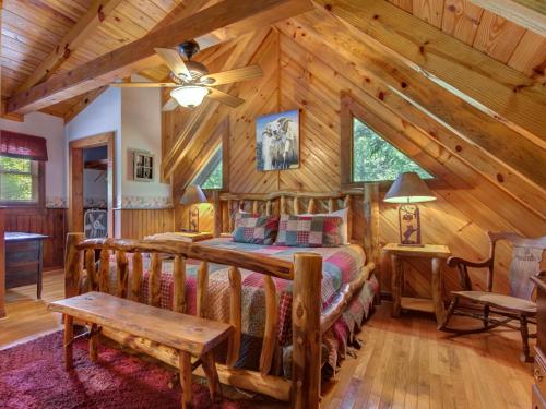 a bedroom with a bed in a log cabin at Buckhorn, 2 Bedrooms, Sleeps 6, WiFi, Jetted Tub, Fireplace, Hot Tub in Gatlinburg