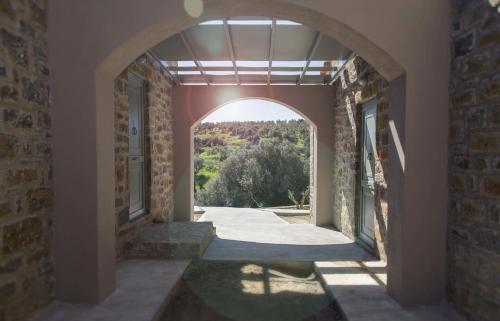 an archway in a building with a view at Afentiko Pigadi in Methoni