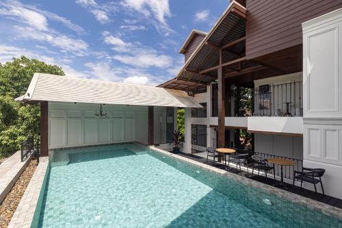 a swimming pool in the backyard of a house at Coucou Hotel in Chiang Mai