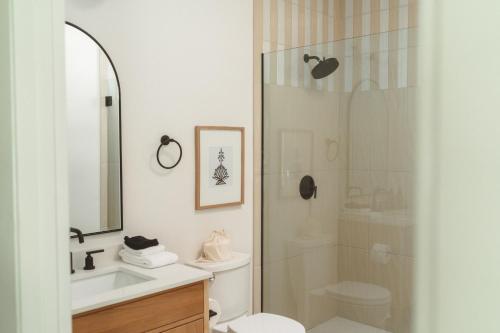 a bathroom with a shower and a toilet and a sink at Yara Hotel - Adults Only in Palm Springs