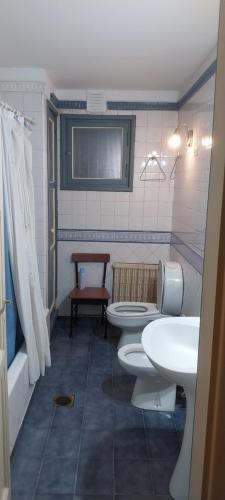 a bathroom with two toilets and a sink at hostel Paso de los Andes in Córdoba