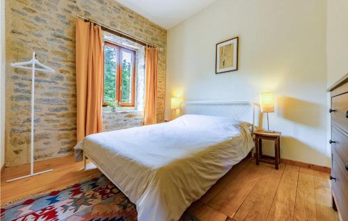 a bedroom with a bed and a window at Gorgeous Home In Caylus in Caylus