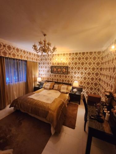 a bedroom with a large bed and a chandelier at Luxury Stay at GOA in Anjuna