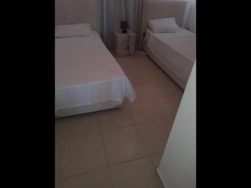 a bedroom with two beds and a tiled floor at Penthouse With Breathtaking Panoramic Views of Mediterranean sea and Mountain in Akanthou