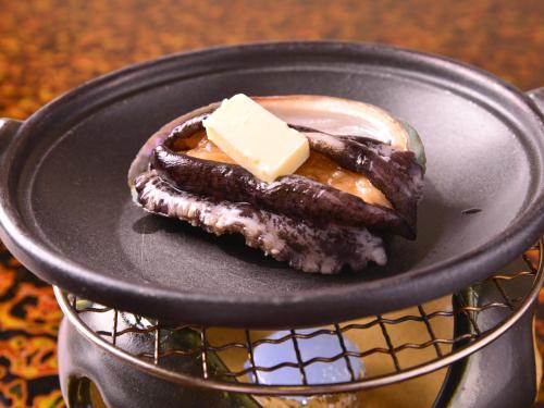 a chocolate dessert with a piece of cheese on a plate at Furuya Ryokan in Atami