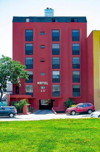 a red hotel with cars parked in front of it at Red Hotel Centric Santiago in Santiago