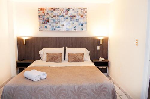 a bedroom with a bed with two towels on it at Red Hotel Centric Santiago in Santiago
