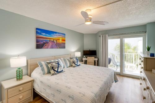 een slaapkamer met een bed en een glazen schuifdeur bij Ocean-View Key Colony Beach Condo with Pool Access! in Key Colony Beach