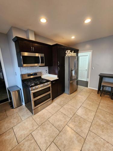 a kitchen with stainless steel appliances and a table at DCU Center, Woo-Sox Stadium, Kelly square in Worcester