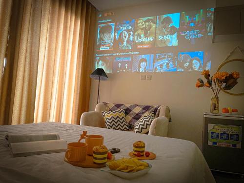 a room with a bed and a couch and a tv at Apartment 1BR-FL25th-R103 Building-Vinhomes Ocean Park in Hanoi
