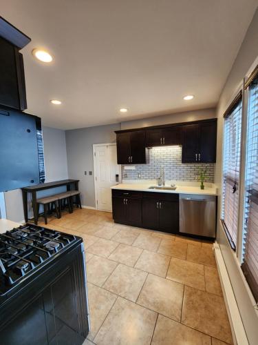 a kitchen with a stove top oven next to a table at DCU Center, Woo-Sox Stadium, Kelly square in Worcester