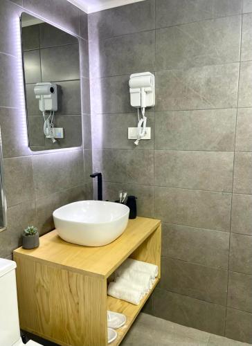 a bathroom with a sink and a mirror at Express Inn in Poti