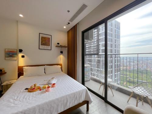 a bedroom with a bed and a large window at Apartment 1BR-FL25th-R103 Building-Vinhomes Ocean Park in Hanoi